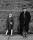 Picture of LS Lowry in the street with a girl standing next to him