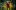 Jason Byrne running towards the camera in a burgundy tracksuit. The background is a blurred green and gold.